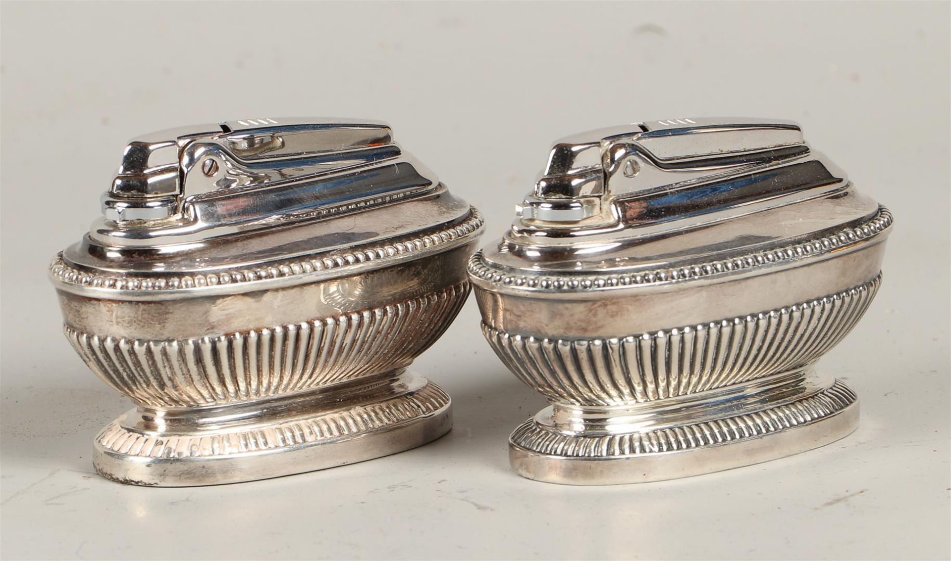 A set of (2) silver plated Ronson, Queen Anne-style table lighters, England, 1960.