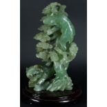 A large Jade statue with decoration of a tiger and a bear near a tree. China, 20th century.