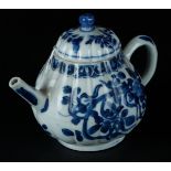 A porcelain ribbed teapot with rich floral decoration and cloud decoration on the handle and spout.