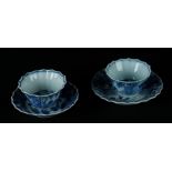 Two porcelain contoured cups and saucers with landscape decor. China, Qianlong.