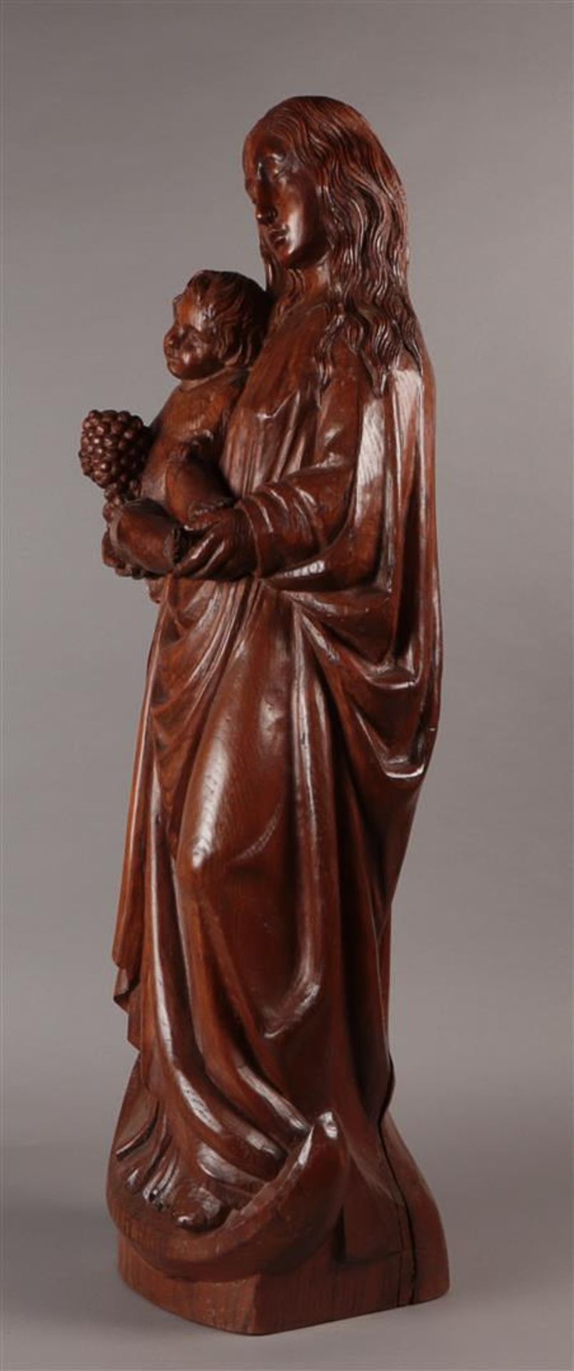 An oak statue depicting Madonna standing on the moon disk, carying the Child Jesus with a bunch of g - Image 2 of 4