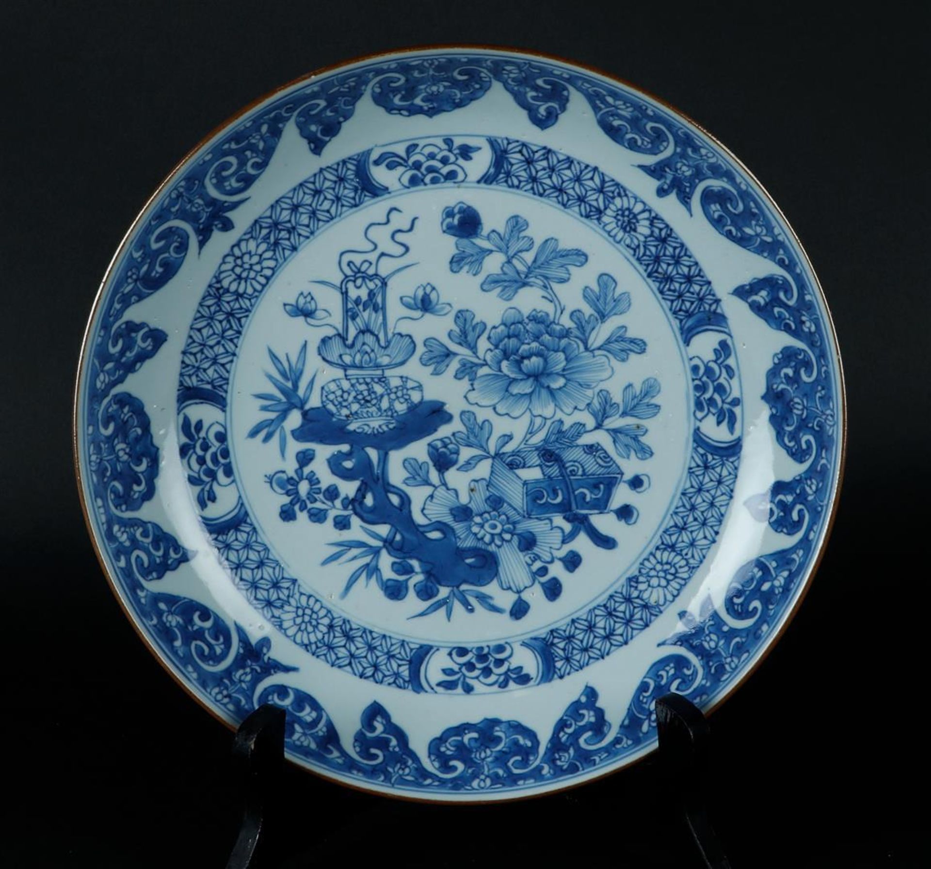 A porcelain deep dish with floral decor, with cachepot on a garden table decor. China, Yongzheng.