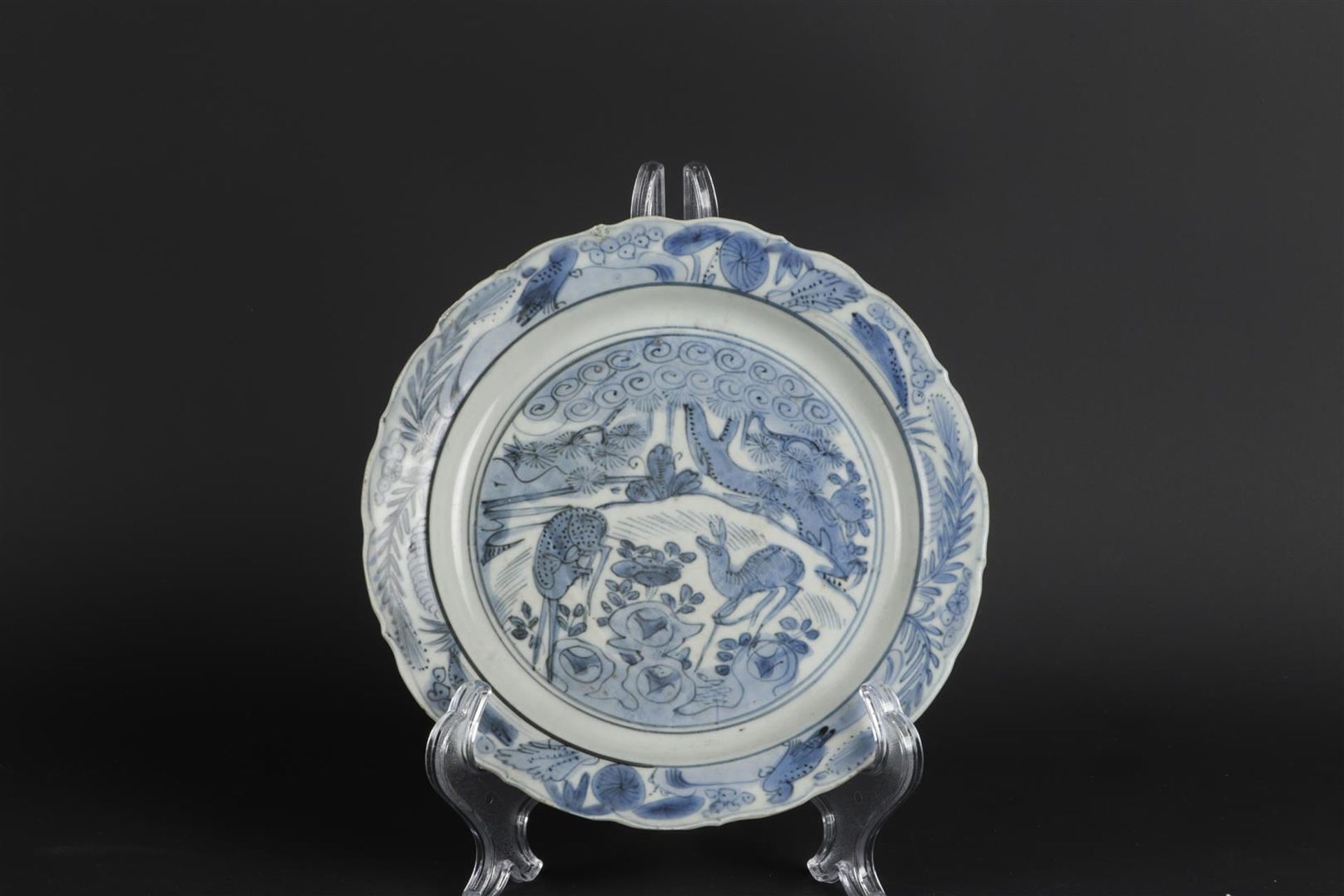 A porcelain plate with deer in landscape decoration in the center, the outside with floral decoratio