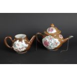 Two porcelain teapots: Famille Rose with chamois leather background, floral decor, one with goose de