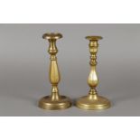 Two bronze candlesticks with angled baluster in the trunk. 17th/18th century.