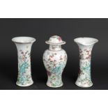 Two porcelain Famille Rose beaker vases and a Famille Rose vase with lid. China, Qianlong.