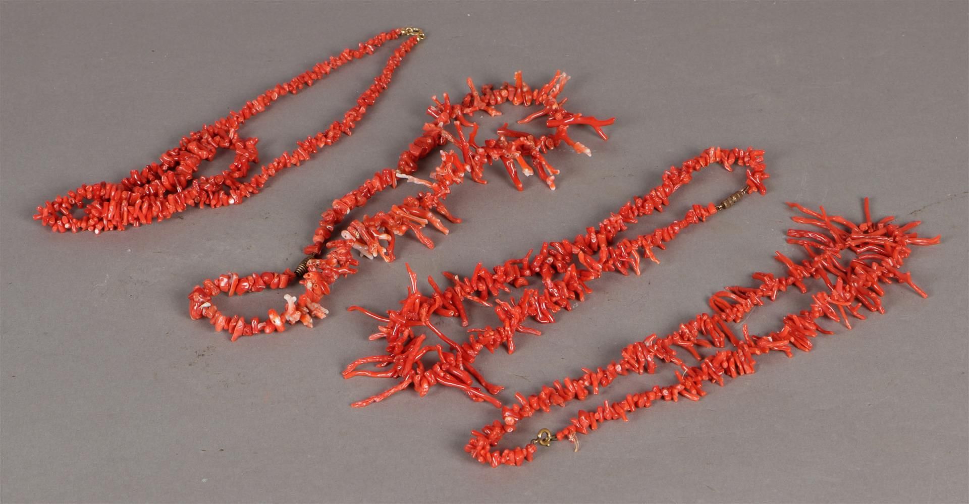 Four red coral necklaces.