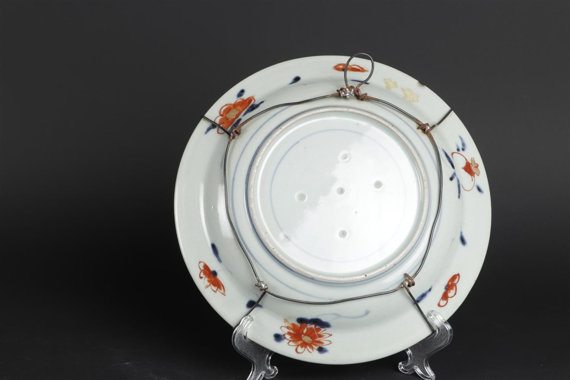 A porcelain Imari plate with a handle basket decor and a border outside. Japanese, early 18th centur - Image 2 of 2