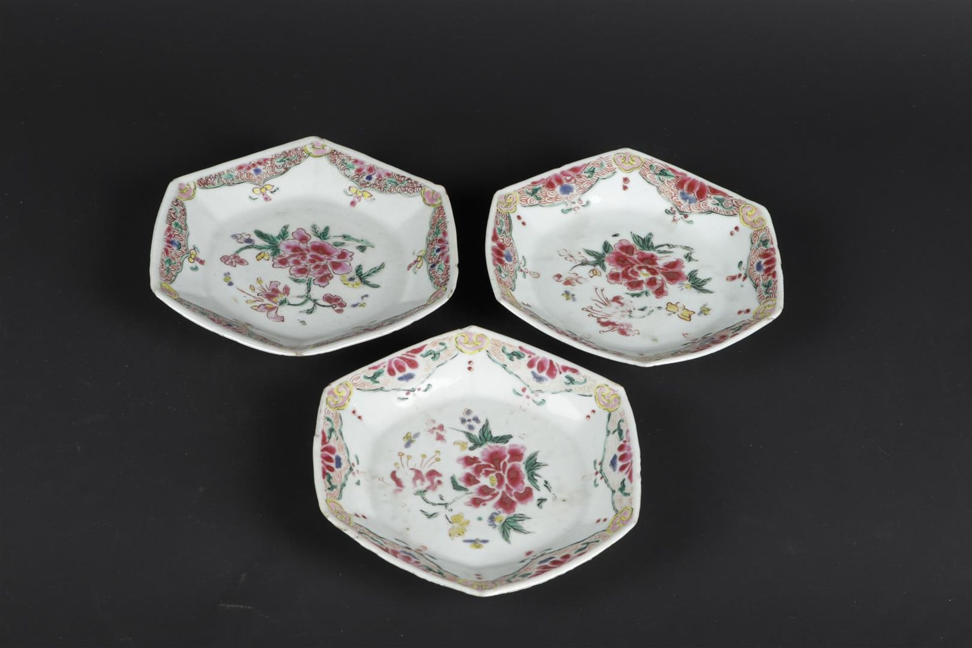 Three porcelain angled Famille Rose plates with rich floral decoration. China, Yongzheng/Qianlong. - Image 3 of 6