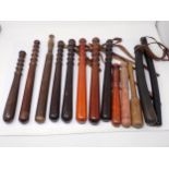 Eleven wooden Police Truncheons and two rubber Truncheons