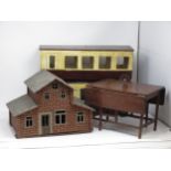 A hand made wooden model of a Barn, a doll's gateleg Table and two wooden railway Coaches