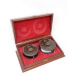 A Hardy Bros. mahogany Presentation Case containing two 1st Edition Golden Prince Presentation Reels