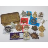 Seventeen British Army Badges, possibly some re-strikes and a reproduction Mary 1914 Christmas Tin