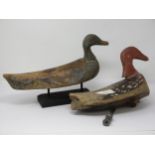 Two carved and painted Continental Duck Decoys, one with tethering weight