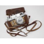 A vintage Camera bearing Leica D.R.P. Ernst Leitz Wetzlar stamp and German Eagle emblem, in