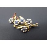 A Sapphire and Spinel flower Spray Brooch claw-set round sapphires to flower centres and oval-cut