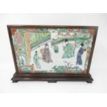 A Chinese porcelain rectangular Panel or Block painted two seated Figures with attendants in famille