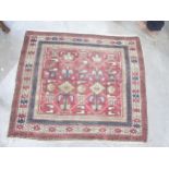 A bordered Shirvan Rug with stylised birds and marks in camel, beige and blue on a red ground, 4ft