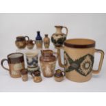 A collection of Doulton Lambeth Stoneware, including Loving Cup, Mug, Jugs, miniature items, some