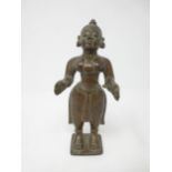 An Indian/Tibetan bronze standing woman with plaited hair and outstretched arms, 6in