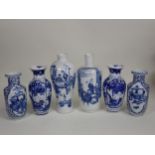 A collection of 19th Century Chinese blue and white Vases, including a pair with panels of vases,