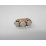 An Opal three stone Ring claw-set three round stones in 9ct gold, ring size J 1/2.