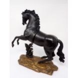 A bronze Figure of a rearing horse on a rustic rocky base 12in H