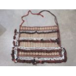 An unusual Kelim Bag with rows of small diamonds in beige and brown, four rows of white ceramic