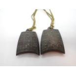 A pair of bronze Weights in the shape of temple bells embossed geometric design, 1 3/4in x 2in