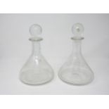 A pair of plain glass Ship's Decanters with bull's eye stoppers