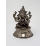 A white metal Figure of Ganesh holding attributes on circular base, 6in H