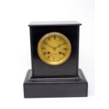 A black marble Mantel Clock with engraved circular brass dial, inscribed Rollin A Paris, striking on