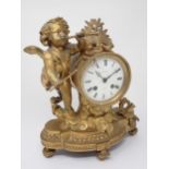 A French Mantel Clock with cherub playing pipe supporting drum clock with white enamel dial,