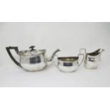 A matched silver three-piece Tea Service of plain oval form, engraved Brownswood greyhound crest,