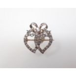 A 19th Century Diamond Brooch the interlocking hearts pavé-set old cut stones throughout in silver