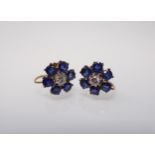 A pair of Flower Cluster Earrings each claw-set brilliant-cut diamond within a frame of six round