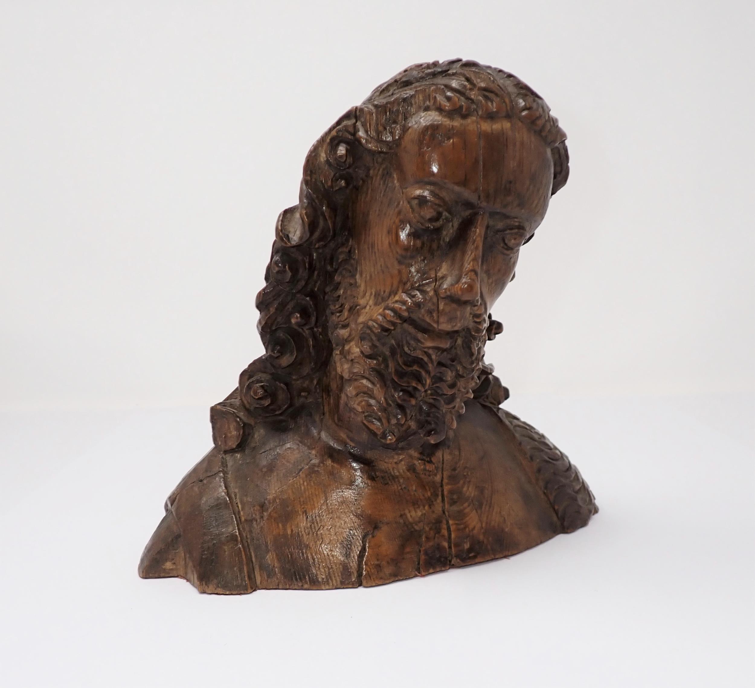 A finely carved wooden Bust, possibly of John the Baptist, with fleece over right shoulder, possibly