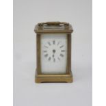 A small French brass Carriage Clock, the white enamel dial marked with Roman numerals, 3½in H