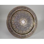 An early 20th Century Syrian brass Charger inlaid script in silver and copper, 13 1/2in diameter