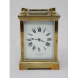 A brass cased Carriage Clock, with presentation inscription to the top, the white enamel dial