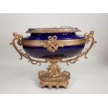 A blue porcelain and gilt metal Jardiniere, possibly French, with winged cherub handles to the