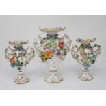 A Dresden three piece Garniture of two handled Vases, each floral encrusted and painted small