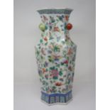 A Chinese famille rose shaped octagonal tall Vase painted flowering shrubs and butterflies,