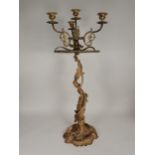 A large gilt metal three branch, four sconce Candelabra with pierced leafage and serpent column, and