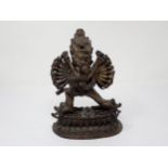 An Indian bronze erotic Figure Group, the horned figure with multiple arms and legs, 8 1/2in H