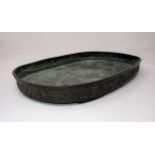 A Chinese shallow metal oval Dish, possibly for narcissus bulbs, outer side embossed good luck