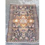 A small bordered Persian Rug with central shaped medallion having ochre ground, the surmount with