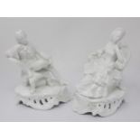 A pair of Continental porcelain white glazed Figurines of seated lady and gentleman on rococo