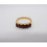 A Ruby five stone Ring claw-set round stones, Continental marks to outside of shank, ring size J