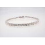 A Diamond Tennis Bracelet having fifty articulated links each claw-set brilliant-cut stone, total